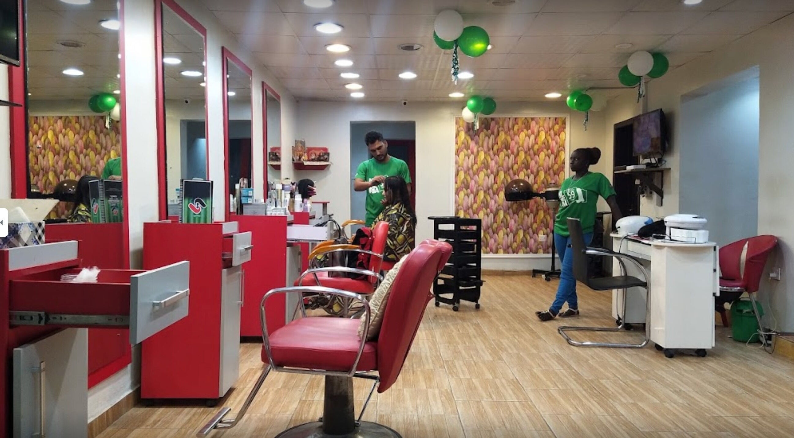 Studio Strands salon in Lagos, NG, featuring chic red styling chairs and professional hair services.