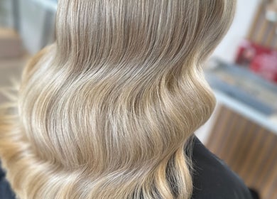 Smooth, wavy blonde hair styled at Clare Elizabeth Colour & Styling Studio, Wirral, England, GB.
