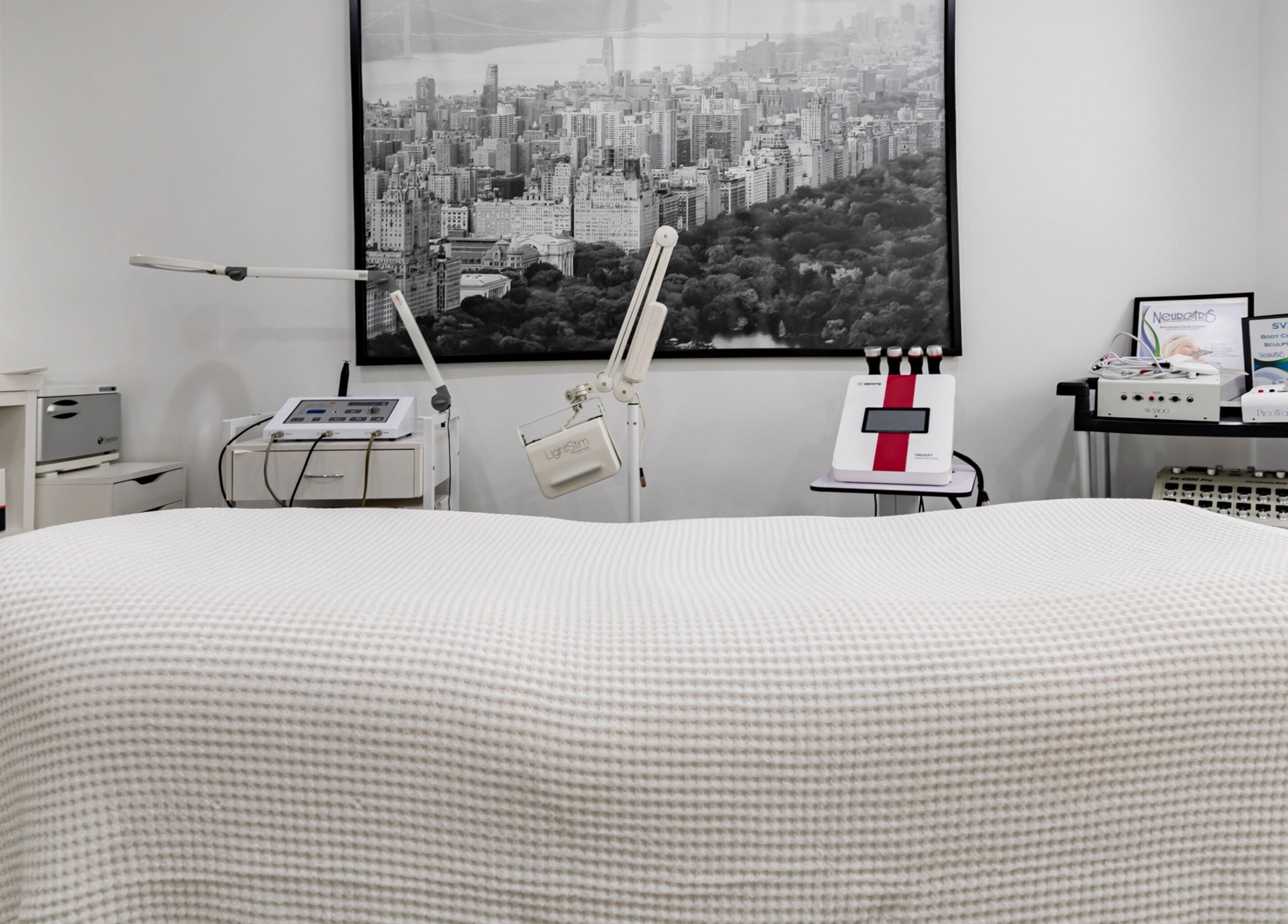 Aesthetic room at The Renew Anti-Aging Center, New York, New York, US, featuring sleek therapeutic equipment.