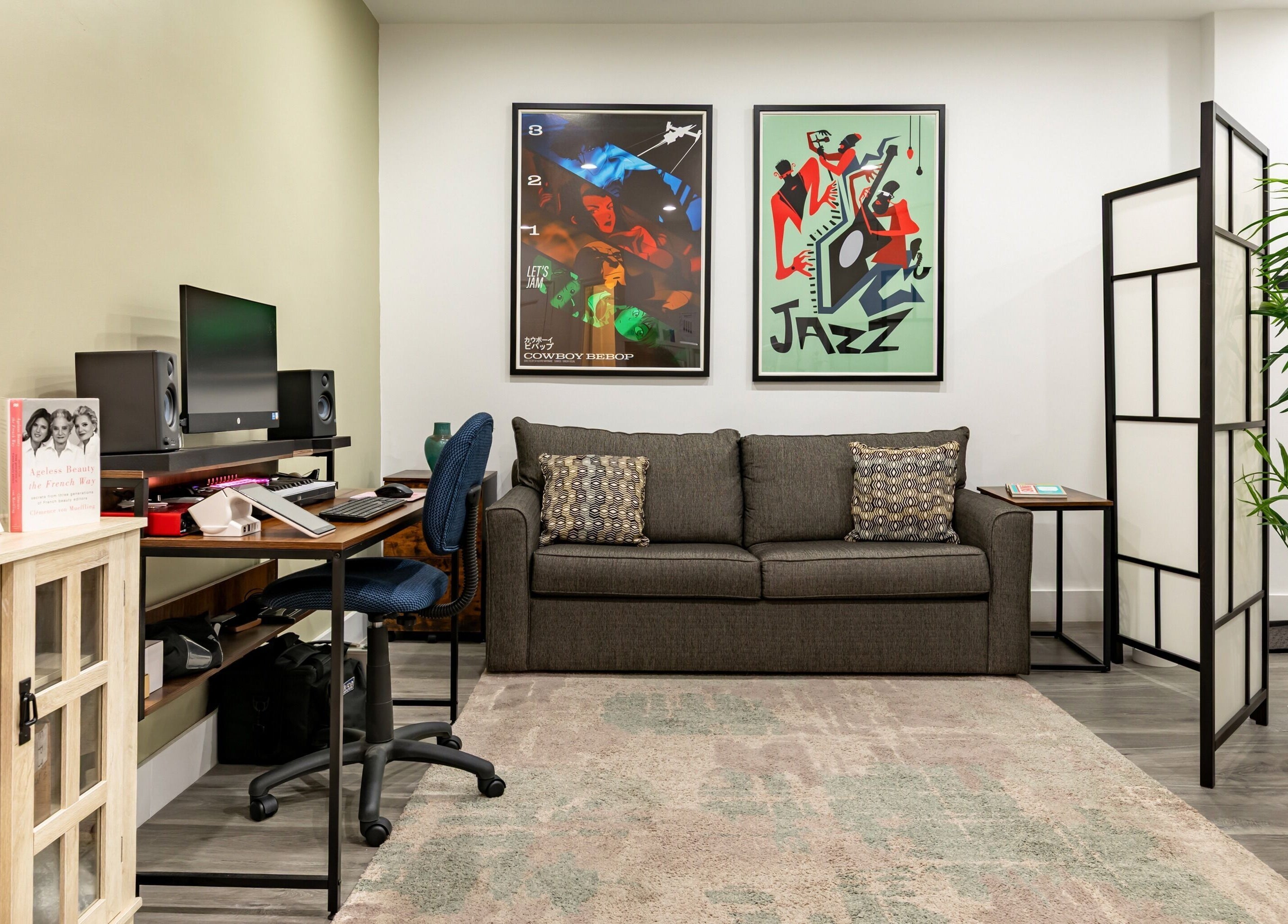Stylish lounge in The Renew Anti-Aging Center, New York, NY, US featuring a sofa, desk, and vibrant posters.