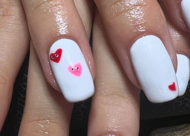 White nail art with heart designs at Blush beauty studio, Henfield, England, GB.