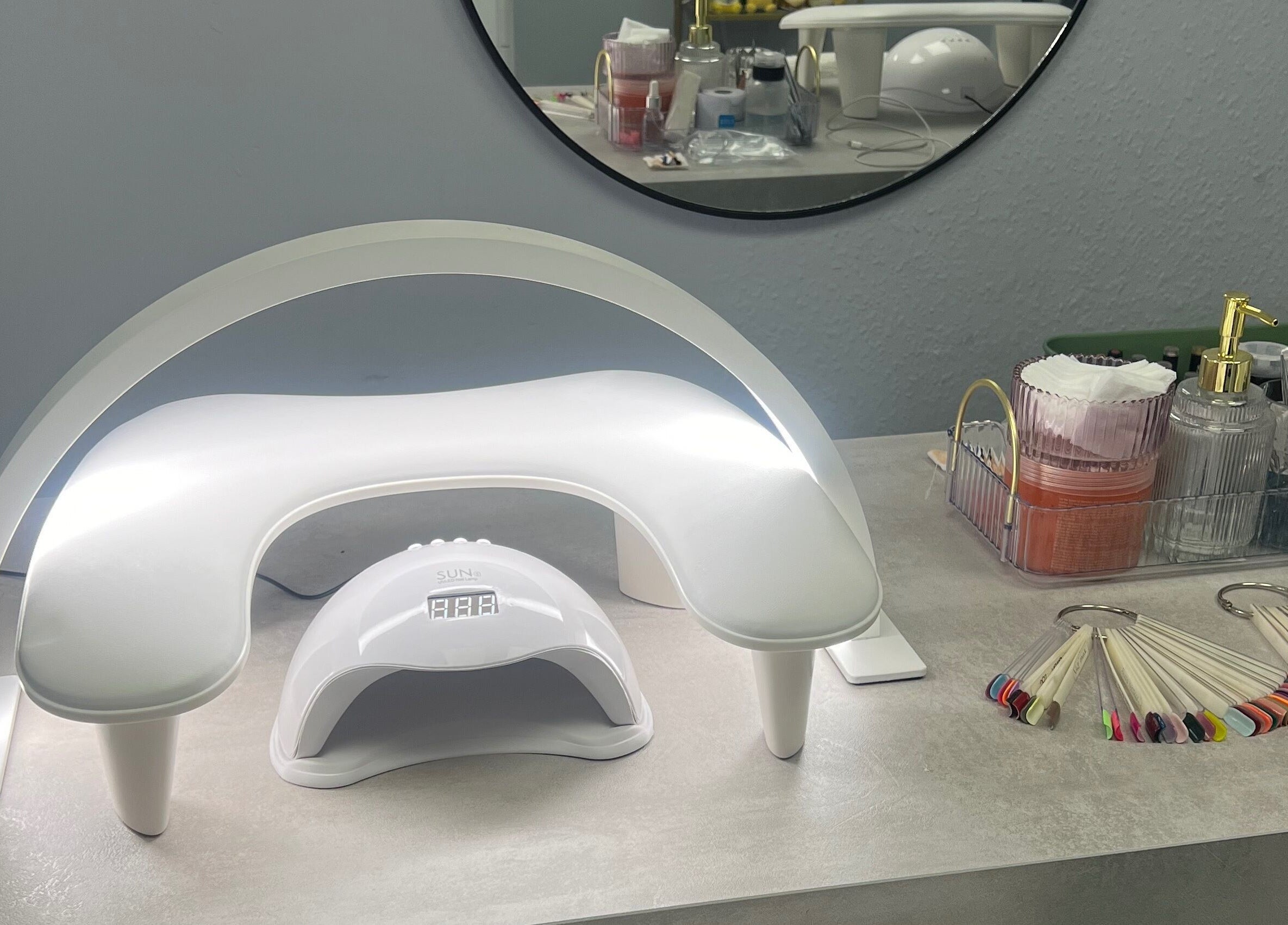 Nail station at Blush Beauty Studio, Henfield, England, GB featuring curing lamp and manicure tools.