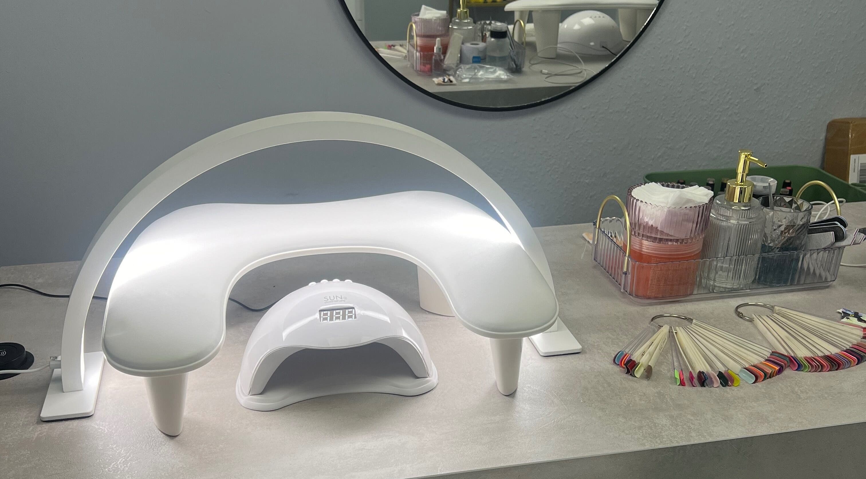 Nail station at Blush Beauty Studio, Henfield, England, GB featuring curing lamp and manicure tools.