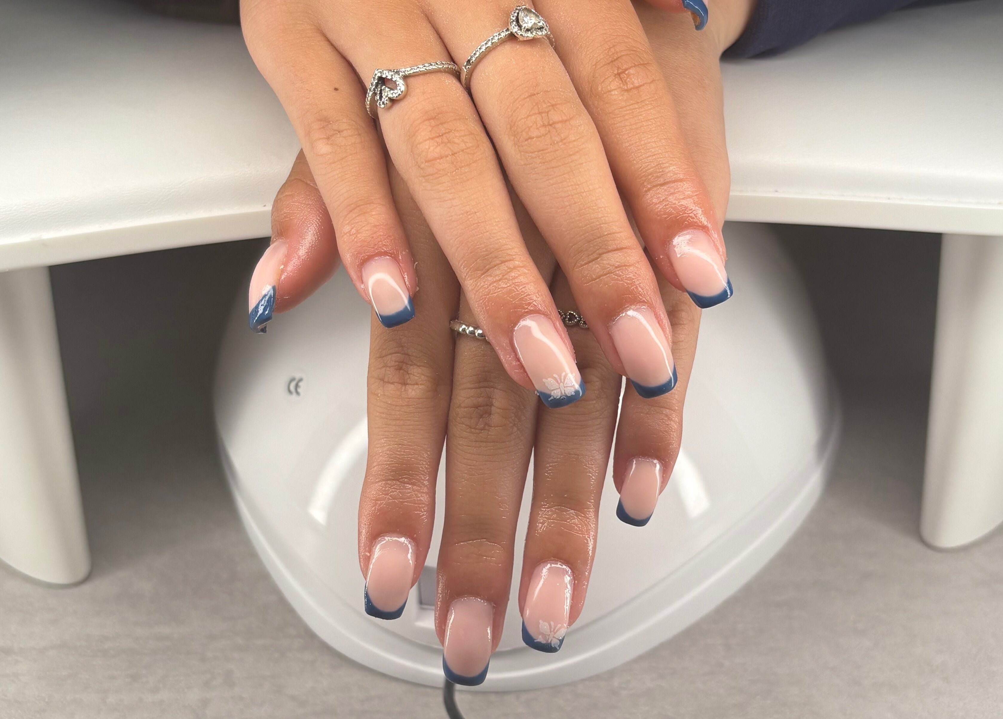 Stylish blue-tipped nails at Blush Beauty Studio, Henfield, England, GB.