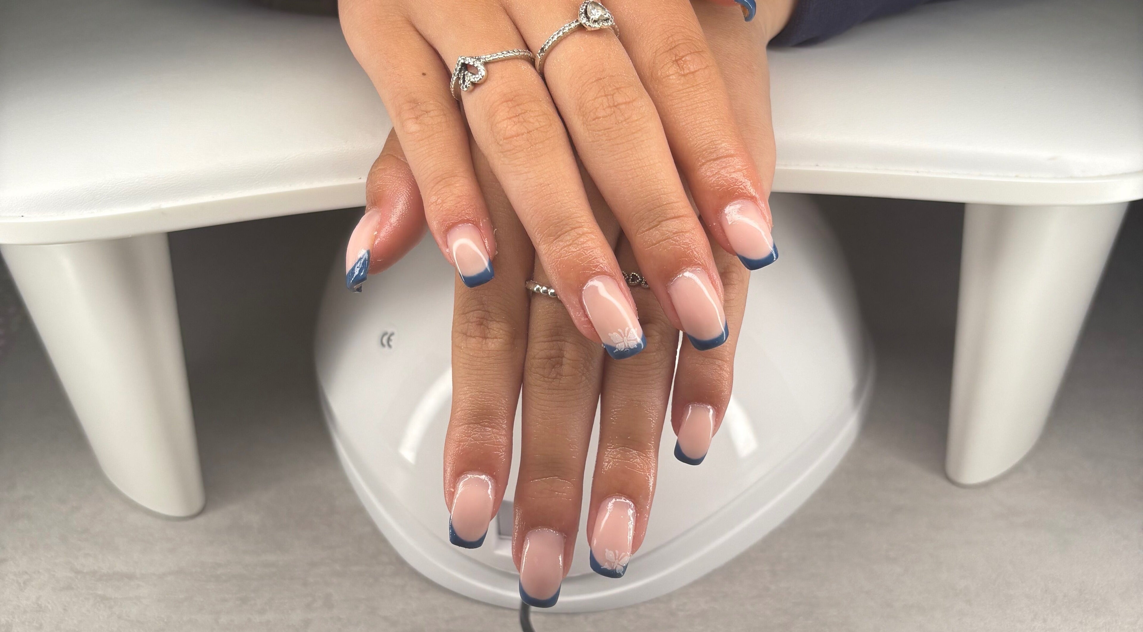 Stylish blue-tipped nails at Blush Beauty Studio, Henfield, England, GB.