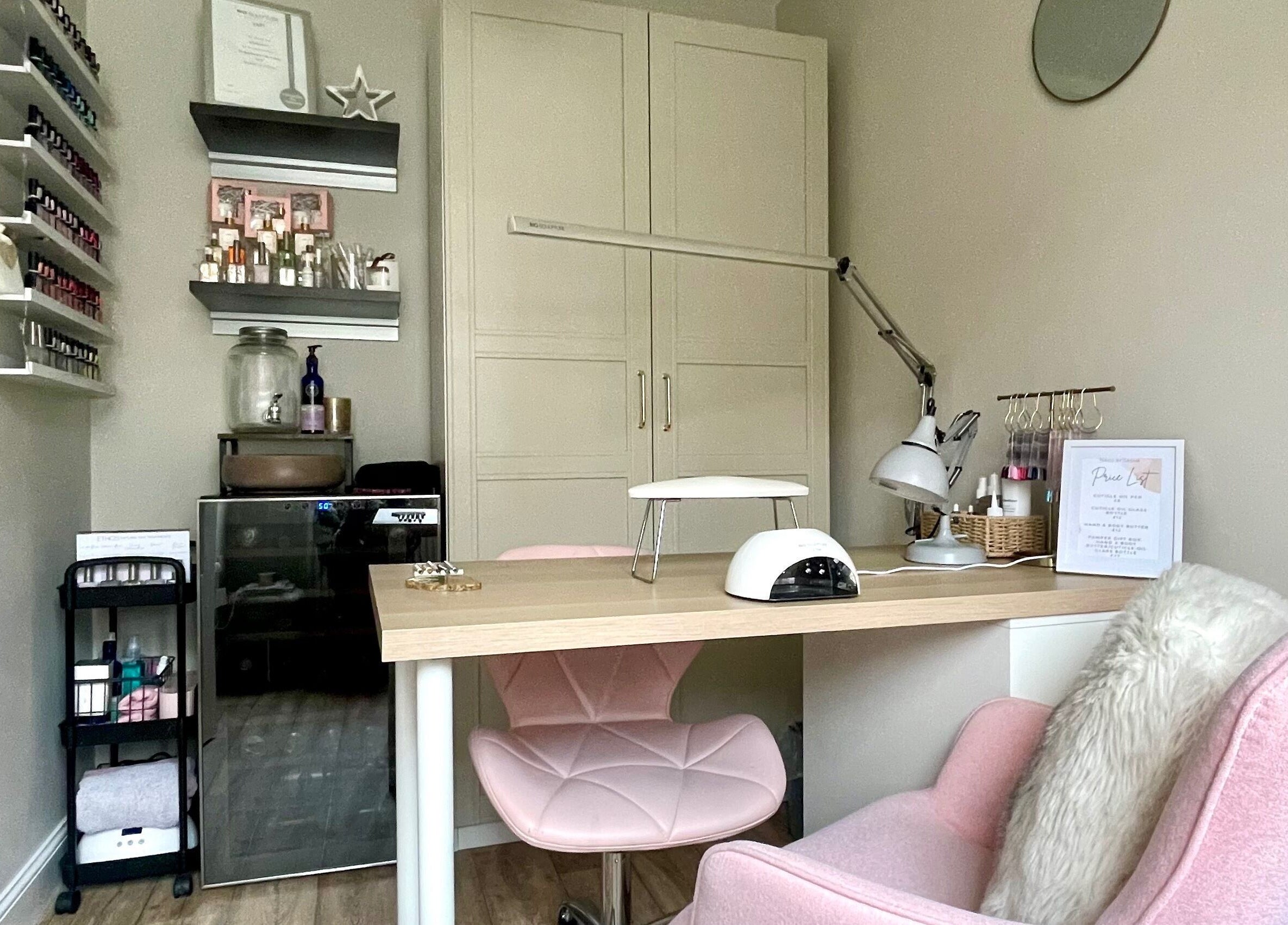 Elegant nail salon desk at Nails by Tasha, North Hykeham, England, GB featuring pink chairs and manicure tools.