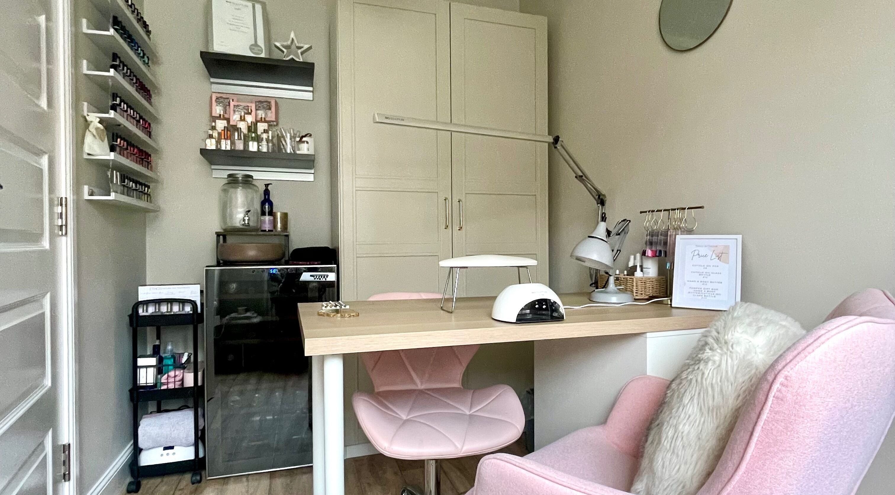 Elegant nail salon desk at Nails by Tasha, North Hykeham, England, GB featuring pink chairs and manicure tools.