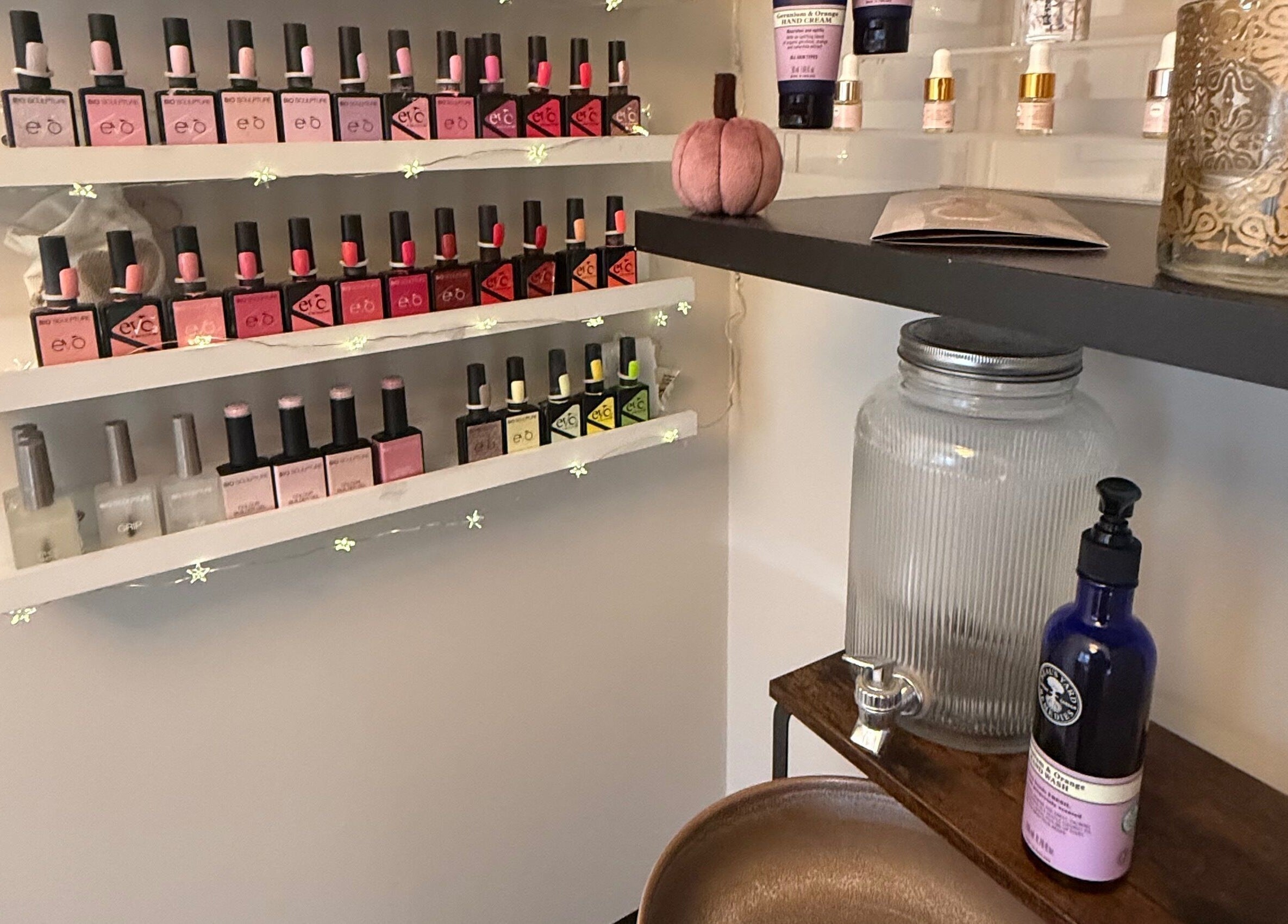 Nail polish display at Nails by Tasha, North Hykeham, England, GB. Shelves full of vibrant polish bottles.