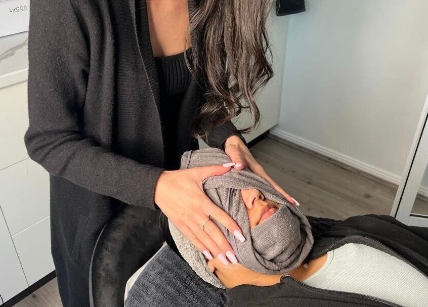 Woman receiving a calming facial wrap at Laser and Skin by Mabelle, Seven Hills, New South Wales, AU.
