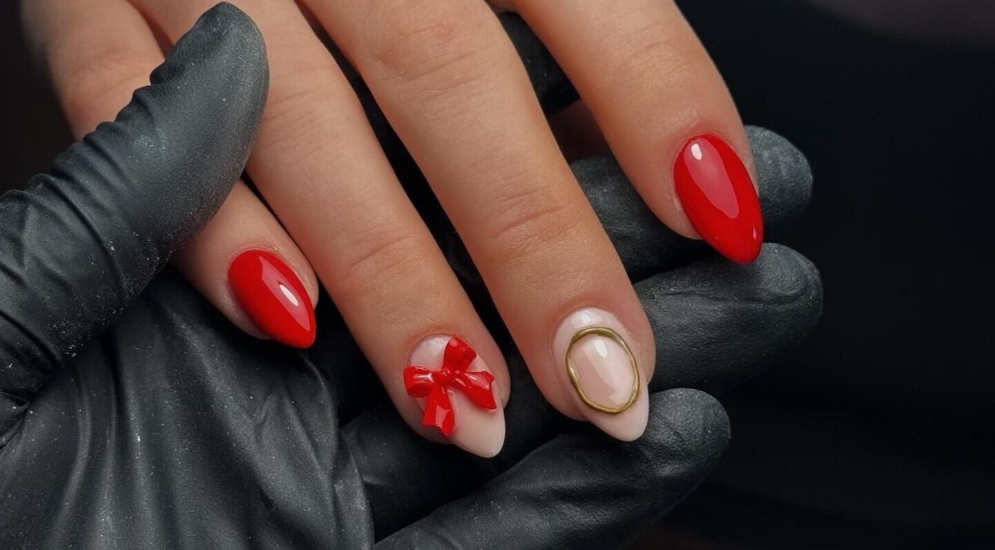 Elegant red nails with artistic design at Altrd. Cosmetics, Huntington, England, GB.