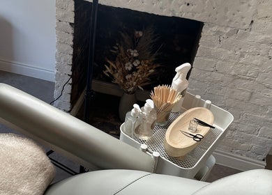 Relaxing treatment setup at RS Artistry, S18 Face Clinic, Dronfield, England, GB with tools and a comfy chair.