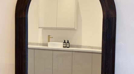 Elegant mirror view at RS Artistry, Dronfield, England, GB showcasing modern sink and cabinetry.
