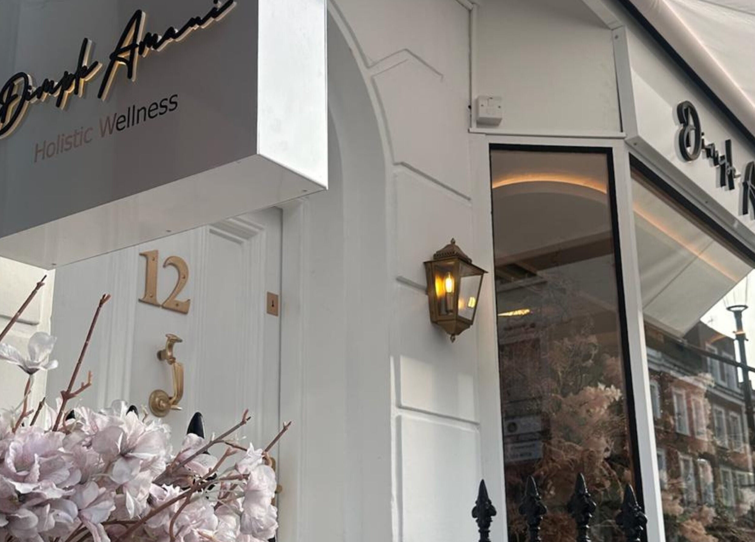 Entrance of Dimple Amani Knightsbridge in London, England, showcasing a stylish exterior with elegant signage.