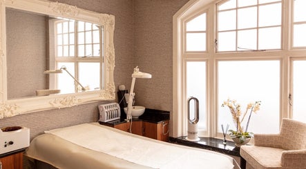 Luxurious treatment room at Mayfair Aesthetics and Beauty, London, England, GB with plush decor and large windows.