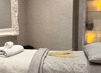 Elegant therapy room at Mayfair Aesthetics and Beauty, London, England, GB. Features luxurious bedding and decor.