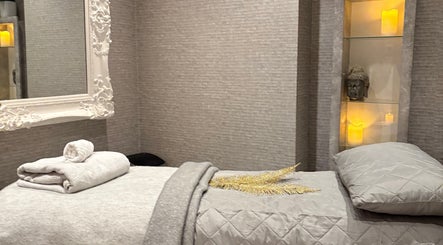 Elegant therapy room at Mayfair Aesthetics and Beauty, London, England, GB. Features luxurious bedding and decor.
