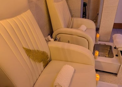 Luxurious pedicure chairs at Mayfair Aesthetics and Beauty, London, England, GB with ambient lighting.