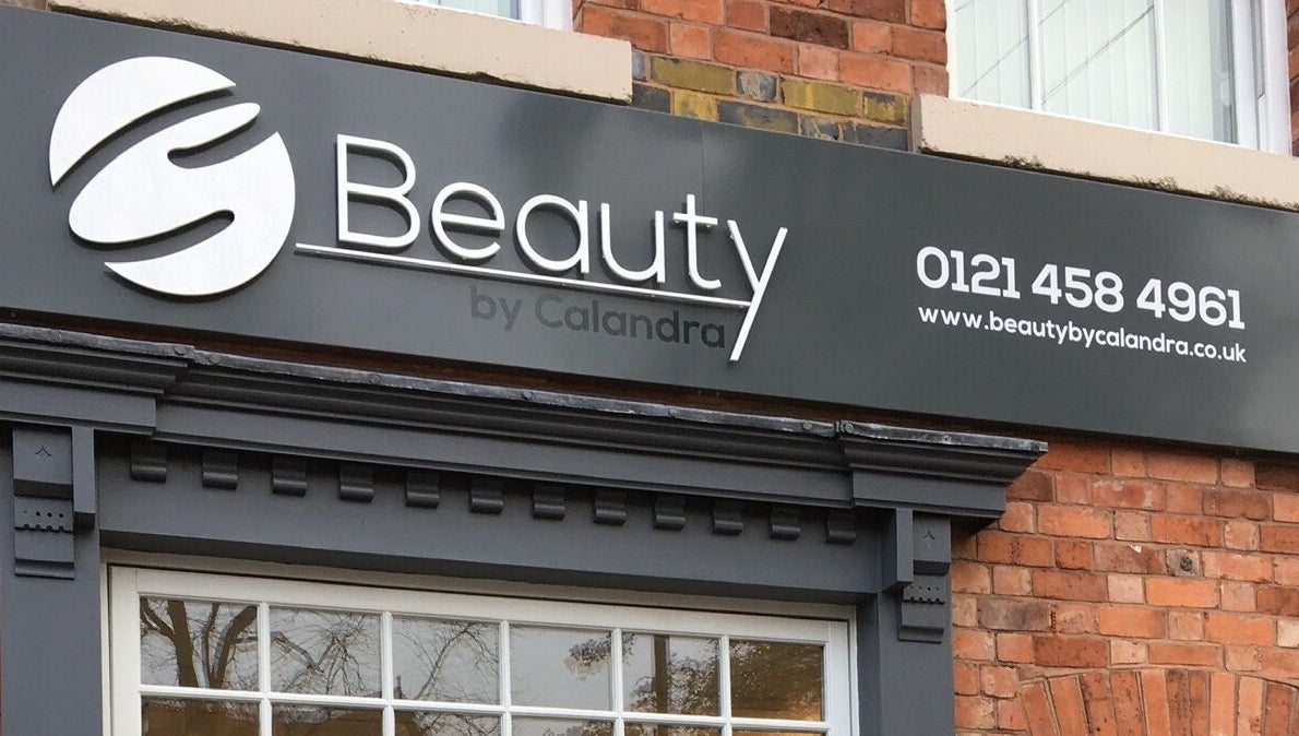 Exterior sign of Beauty by Calandra in Birmingham, England, showcasing its chic design and contact information.