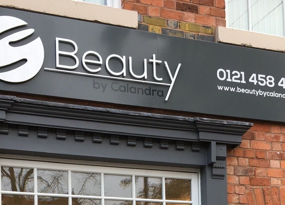 Exterior sign of Beauty by Calandra in Birmingham, England, showcasing its chic design and contact information.