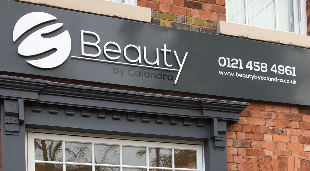 Exterior sign of Beauty by Calandra in Birmingham, England, showcasing its chic design and contact information.