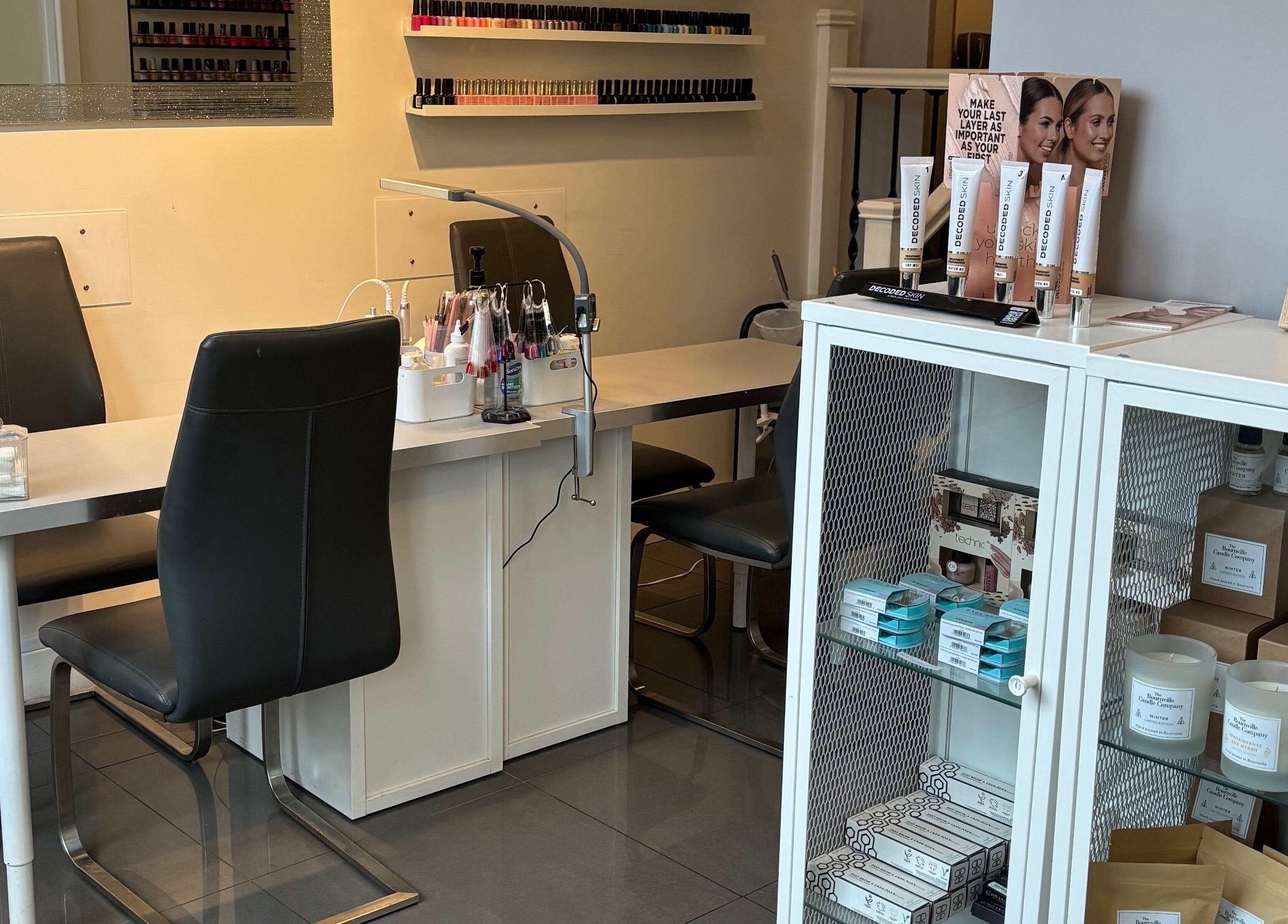 Cozy nail salon station at Beauty by Calandra, Birmingham, England, GB, showcasing beauty products and candles.