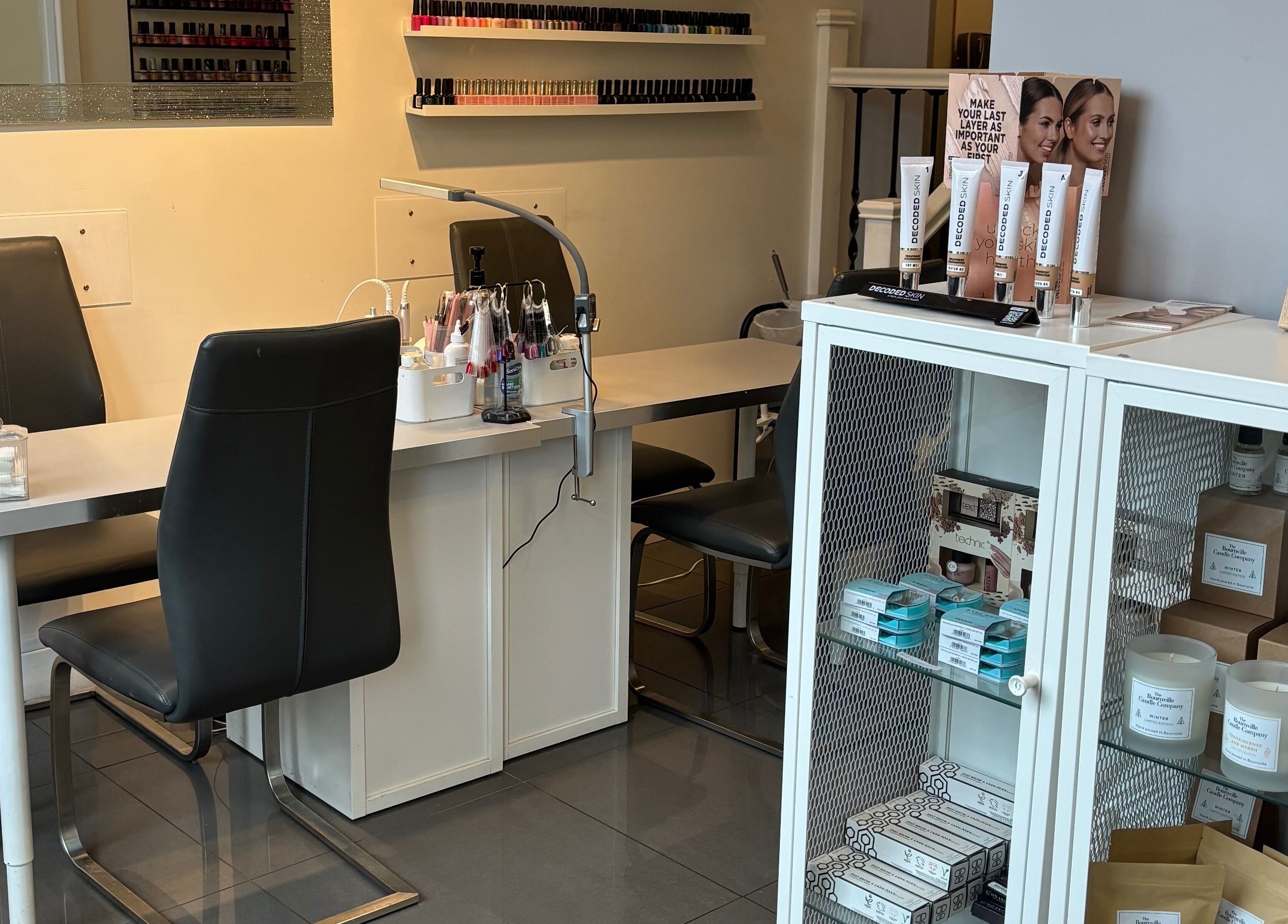 Cozy nail salon station at Beauty by Calandra, Birmingham, England, GB, showcasing beauty products and candles.