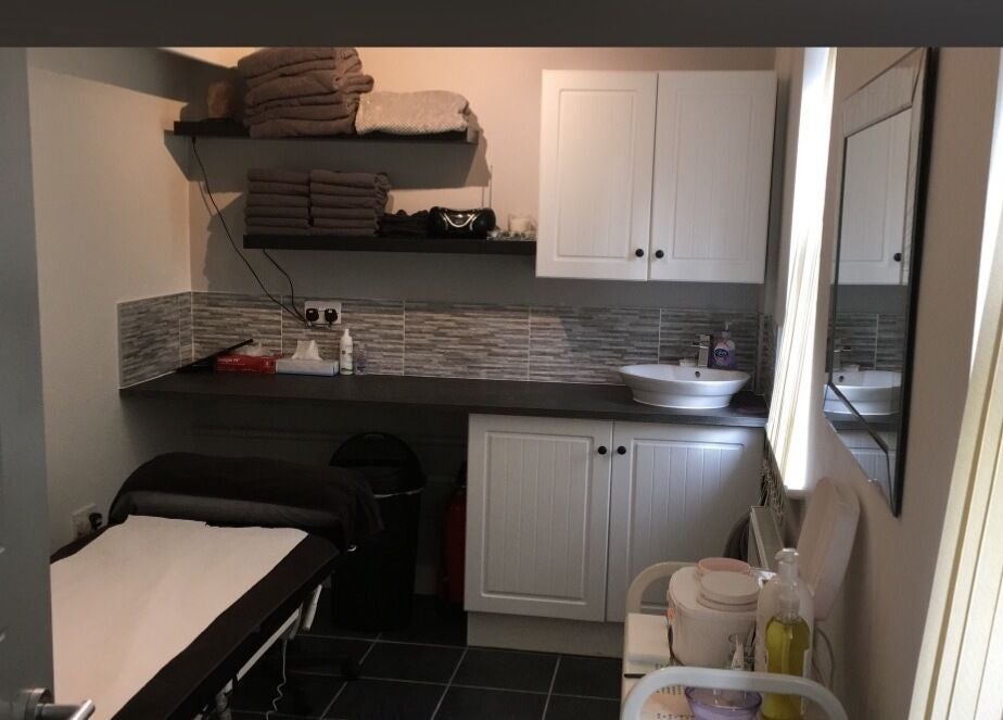 Cozy treatment room at Beauty by Calandra, Birmingham, England, GB, featuring soothing decor and spa essentials.