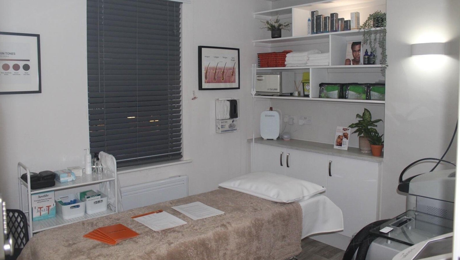 Therabeautic treatment room in Potters Bar, England, GB, featuring a cozy bed and organized shelves.