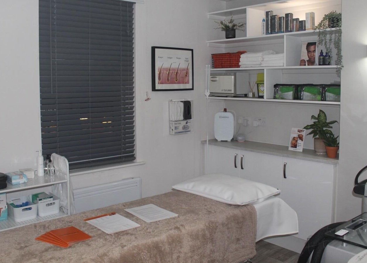 Therabeautic treatment room in Potters Bar, England, GB, featuring a cozy bed and organized shelves.
