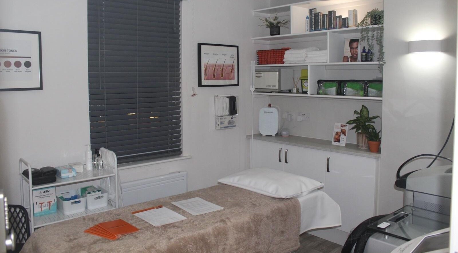 Therabeautic treatment room in Potters Bar, England, GB, featuring a cozy bed and organized shelves.