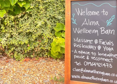 Chalkboard at Alma Wellbeing Barn in Bourn, England, GB welcomes visitors with massage and yoga services.