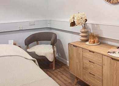 Calm wellness room at Alma Wellbeing Barn, Bourn, England, GB featuring a chair and oak storage.