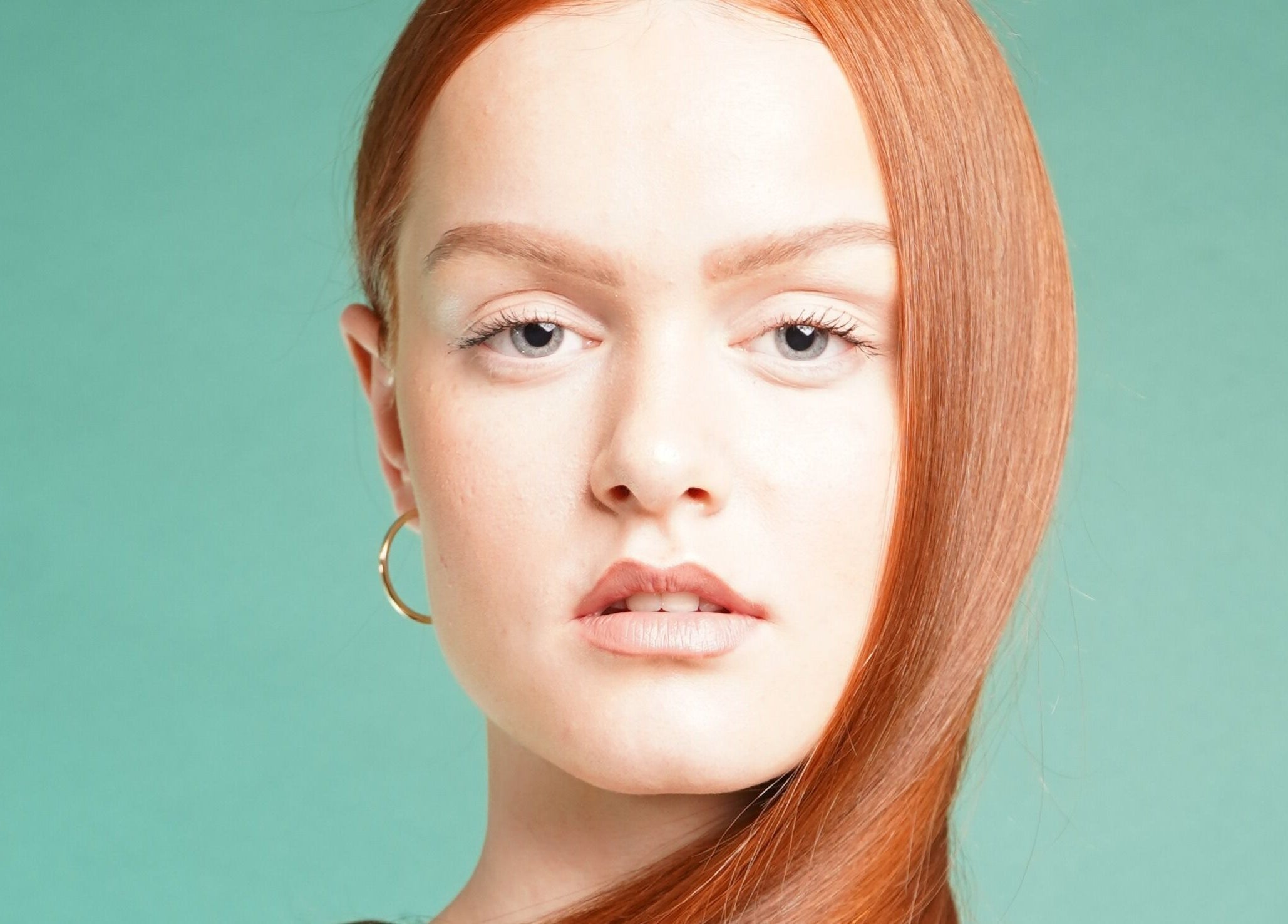 Model with sleek red hair at Jo Johnson Salon, located in London, England, GB. Expert styling showcased.
