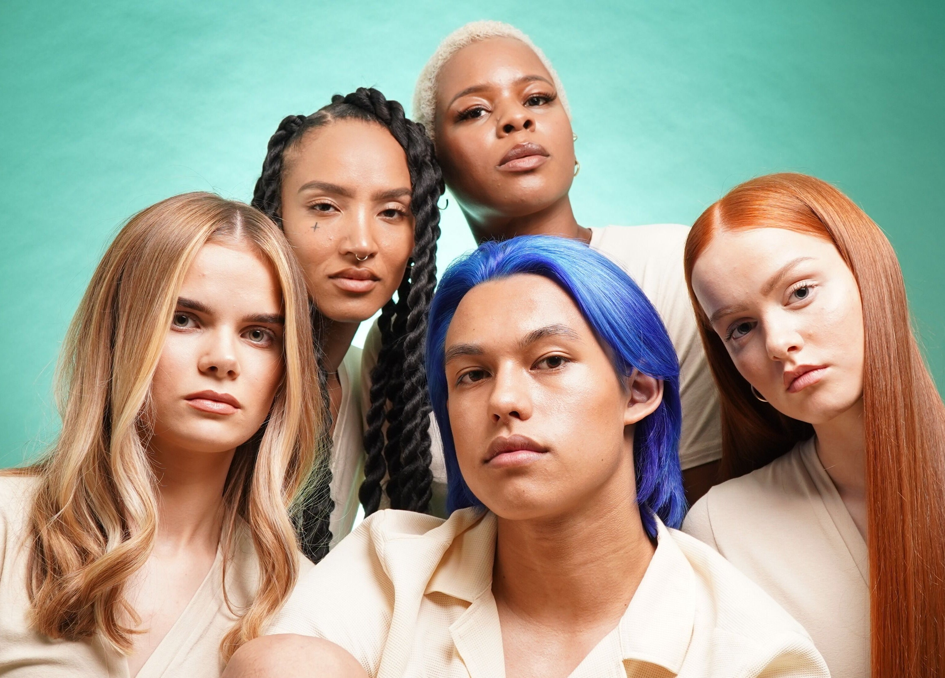 Diverse hair colors and styles showcased at Jo Johnson Salon, London, England, GB against a green backdrop.