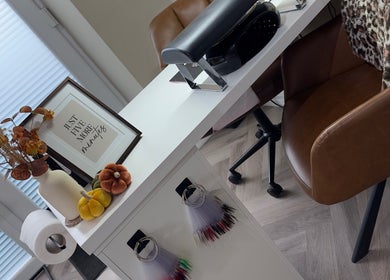 Stylish nail station at Toni Louise Beauty, Llanfairpwllgwyngyll, Wales, with decor and plush seating.