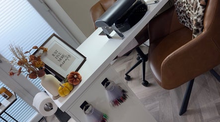 Elegant nail station at Toni Louise Beauty in Llanfairpwllgwyngyll, Wales, GB with decor and sign.