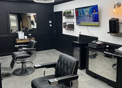 Contemporary salon interior at Sweeneys Catterick in Catterick Garrison, England, GB with modern black chairs.