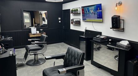 Contemporary salon interior at Sweeneys Catterick in Catterick Garrison, England, GB with modern black chairs.