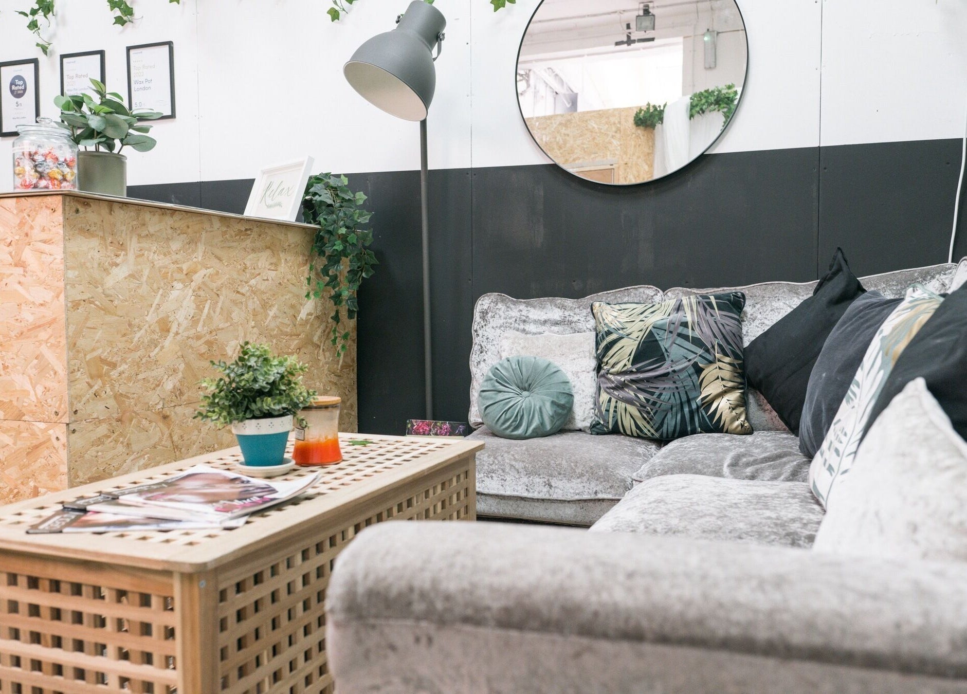 Relaxing seating area at Wax Pot London, featuring plush couches and decor in London, England, GB.