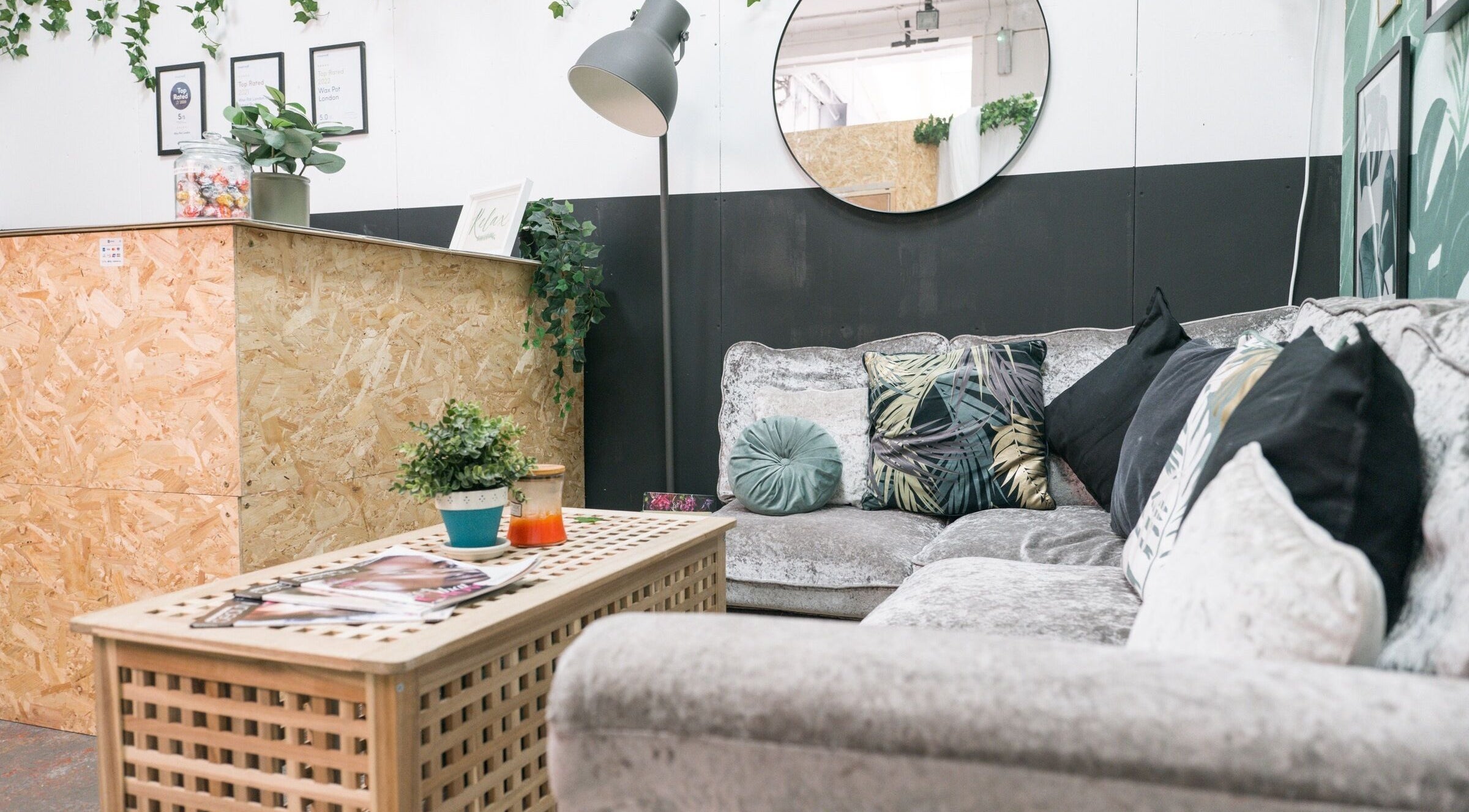 Relaxing seating area at Wax Pot London, featuring plush couches and decor in London, England, GB.