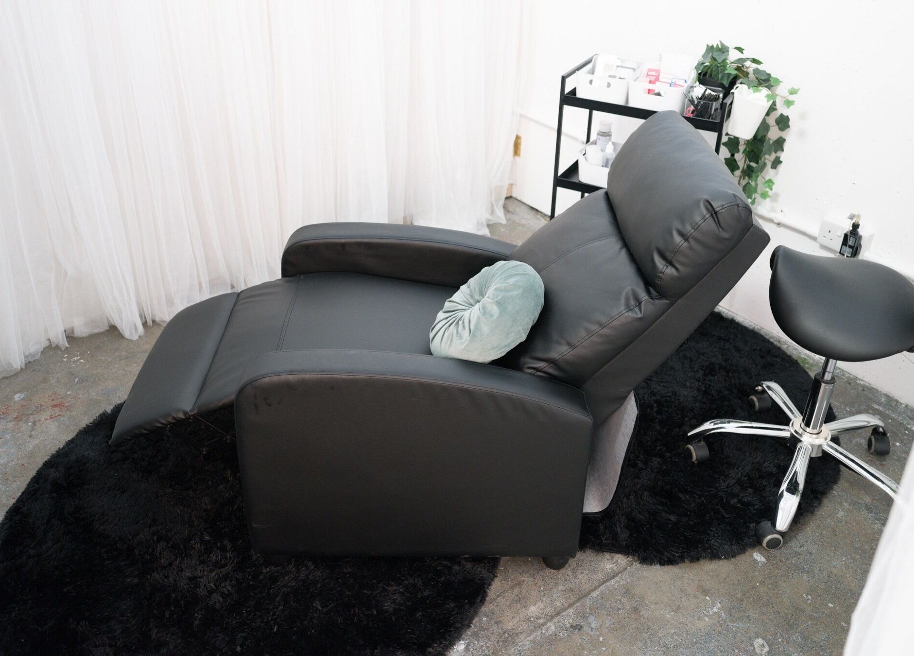 Modern leather recliner with plush pillow at Wax Pot London, London, England, GB.