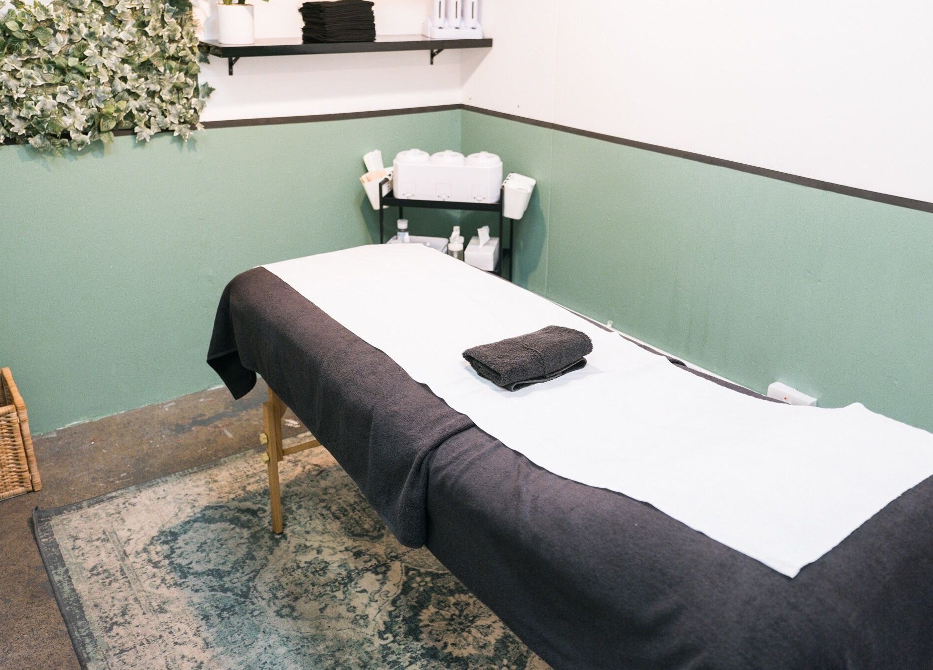 Serene treatment room at Wax Pot London, London, England, GB with calming decor and cozy massage table.