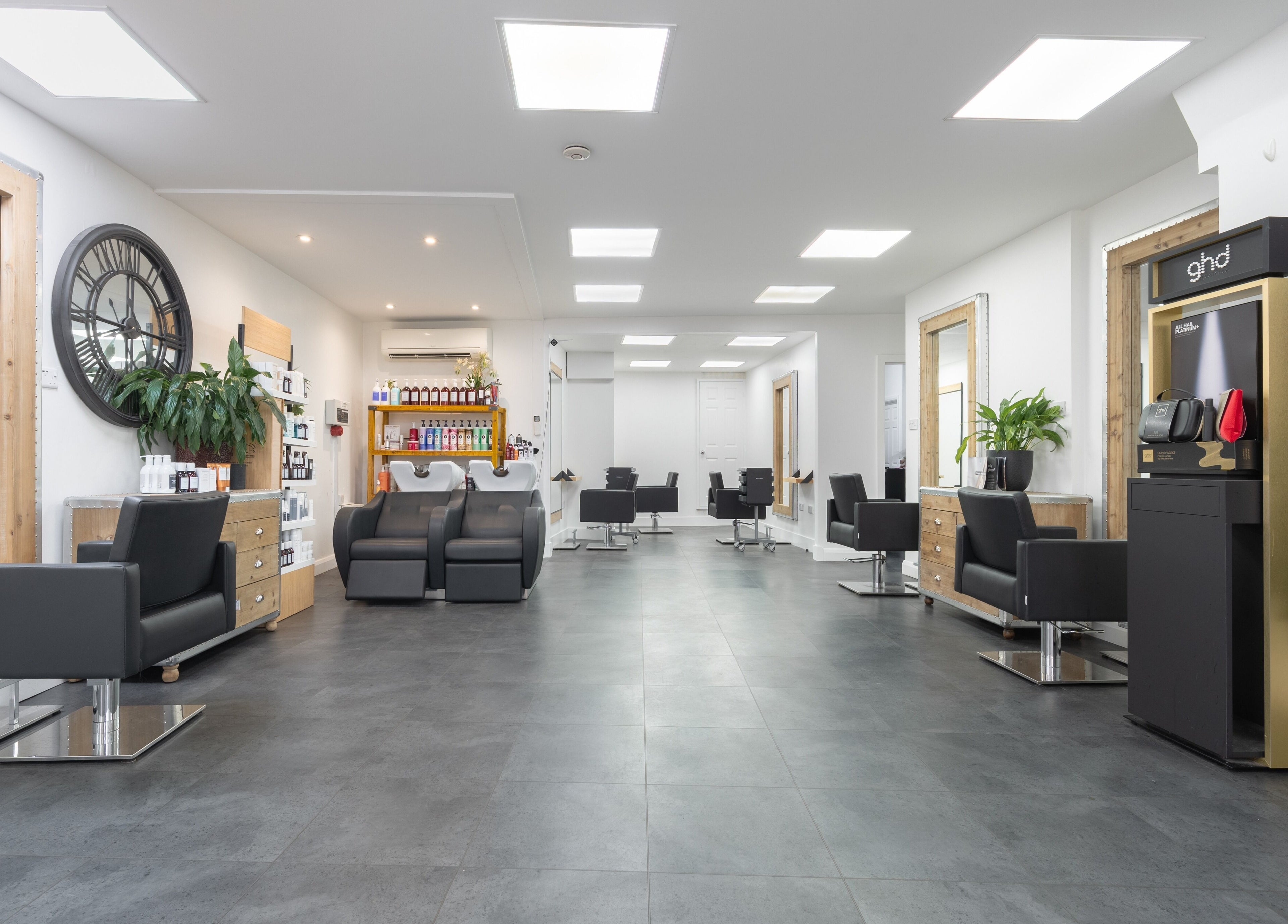 Modern interior of Cara Gibbs Hairdressing, Sale, England, GB, featuring sleek chairs and stylish decor.