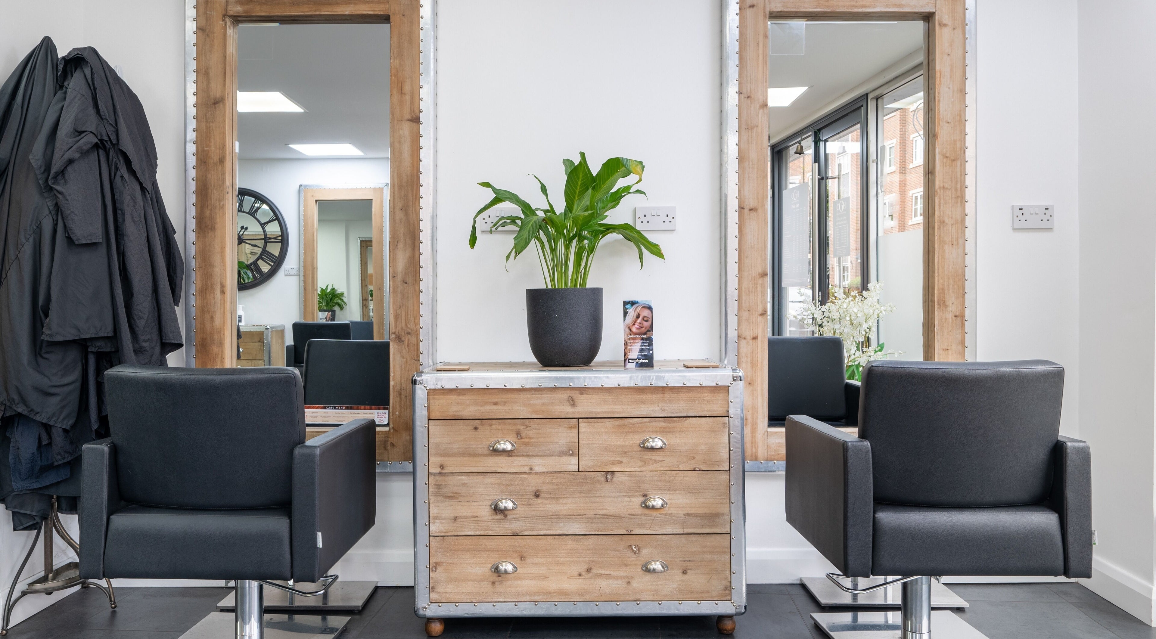 Elegant salon chairs and mirrors at Cara Gibbs Hairdressing, Sale, England, GB, offering stylish hair services.