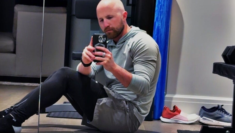 A person taking a selfie in a gym setting at Marks Peak Form in Howell, Michigan, US.