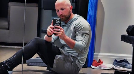 A person taking a selfie in a gym setting at Marks Peak Form in Howell, Michigan, US.