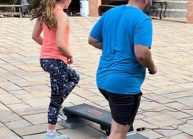 People exercising on a patio at Marks Peak Form, Howell, Michigan, US, enjoying a wellness session.