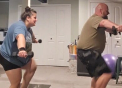 Two adults engage in a dumbbell workout session at Marks Peak Form in Howell, Michigan, US.