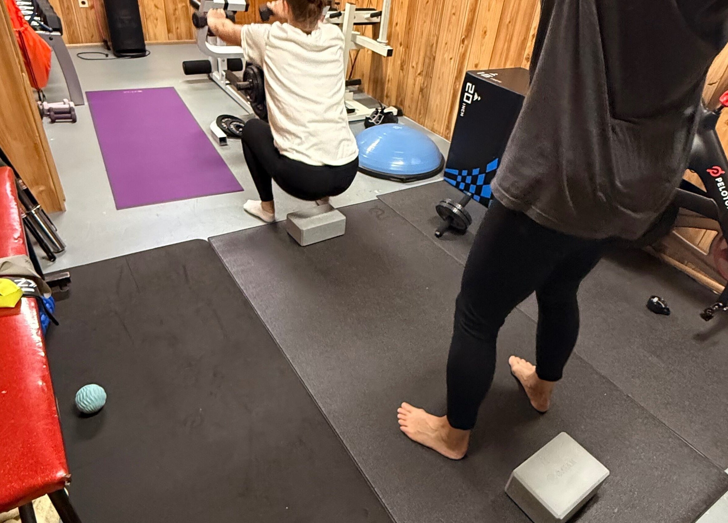 Workout area at Marks Peak Form in Howell, Michigan, US with exercise equipment and mats.