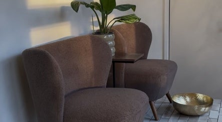 Elegant seating area with plush chairs and plant decor at Lani Nails London, London, GB.